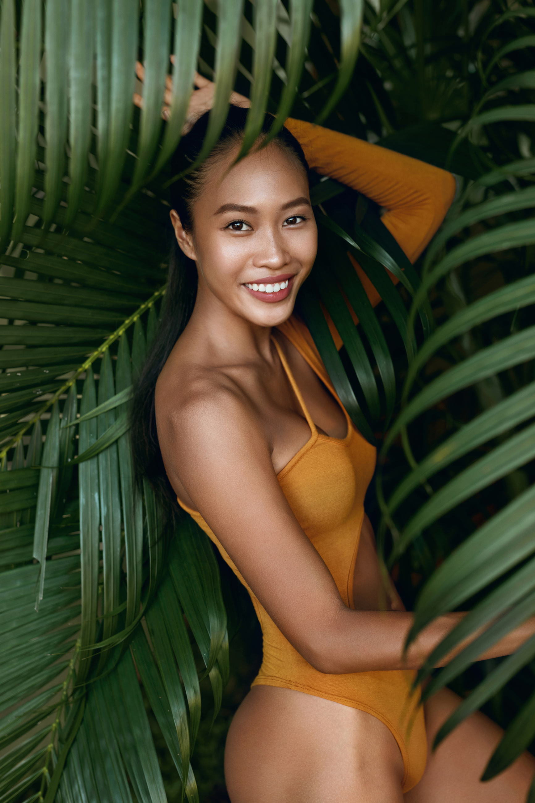 Summer fashion. Happy woman model in swimsuit at tropical nature